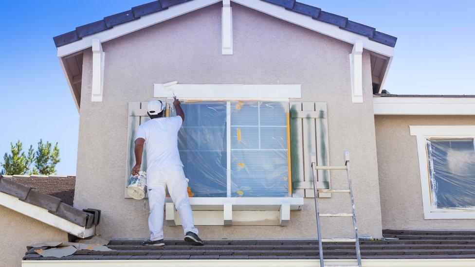 painter working on house