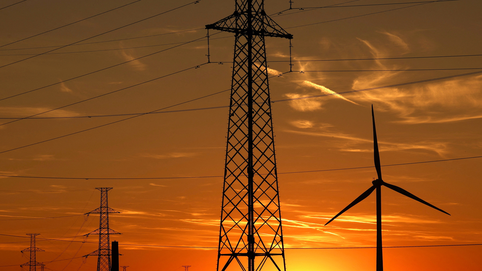 A wind turbine and electrical power pylons