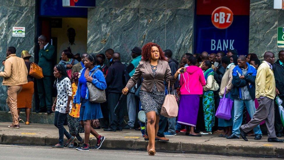 People queuing outside a bank