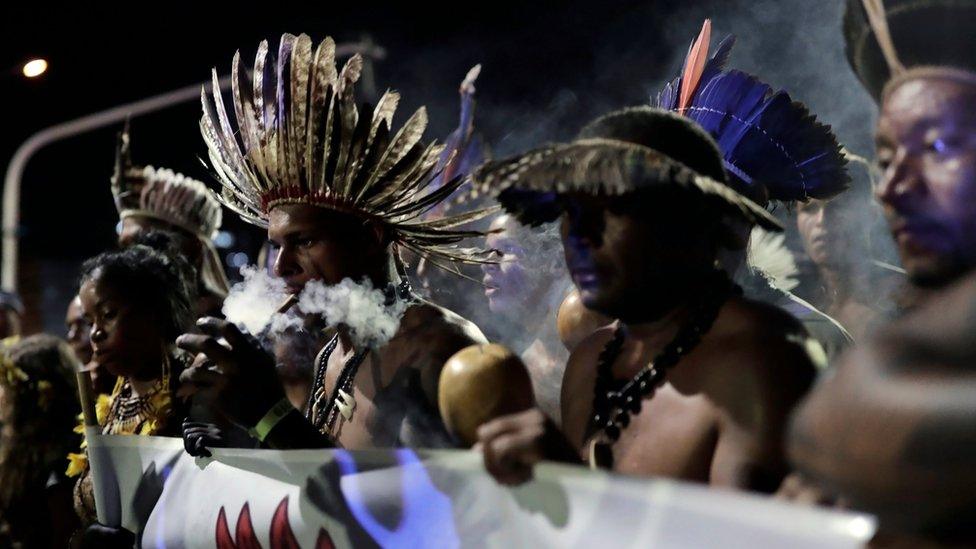 Indigenous men take part in a protest to defend indigenous land and cultural rights