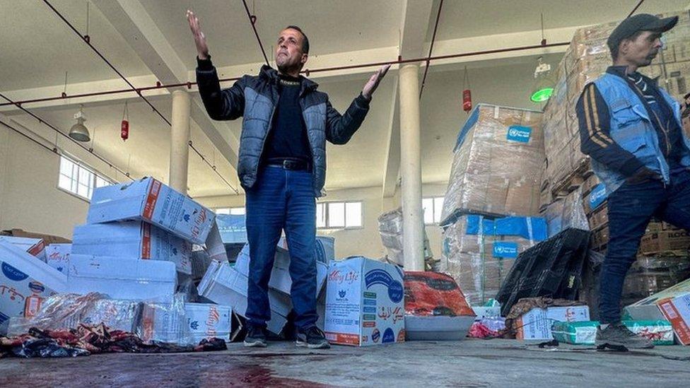 A Palestinian man reacts as blood is seen on the floor at an UNRWA aid distribution centre in Rafah, southern Gaza, following an alleged Israeli air strike. Photo: 13 March 2024