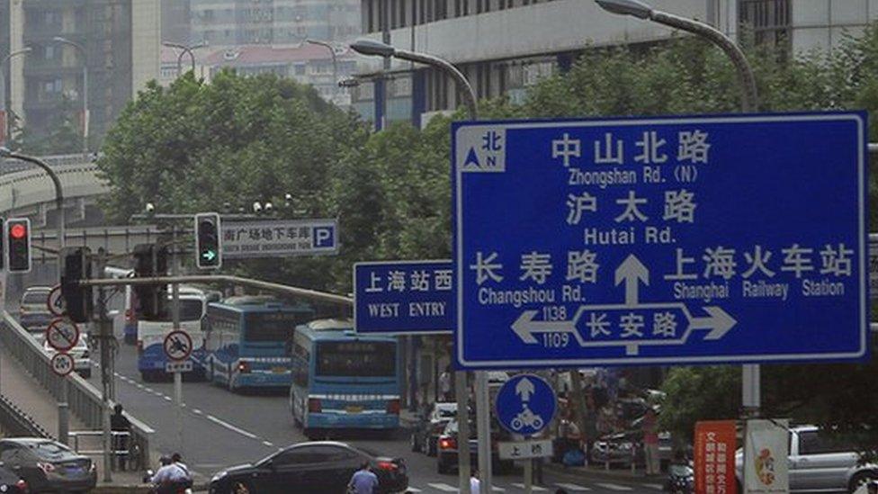 A major street in Shanghai with road signs in both Chinese and English