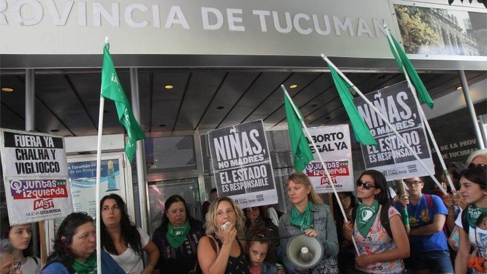 Women hold signs that read "Girls, not mothers. State responsible" during a protest in Buenos Aires, Argentina, 25 February 2019