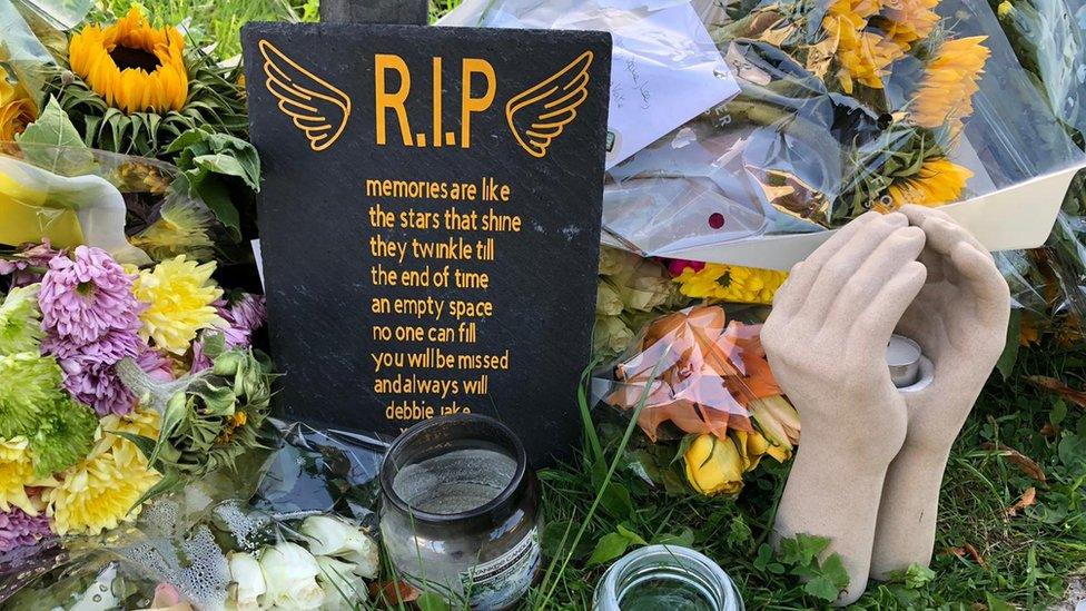 RIP sign with flowers surrounding