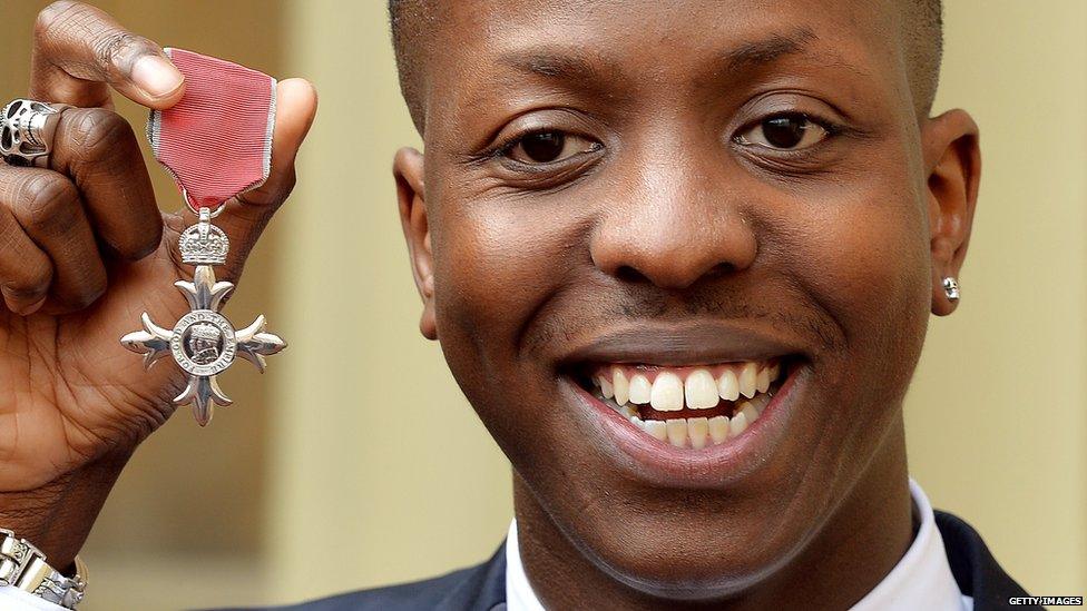 Jamal Edwards holding his MBE medal he received earlier this year