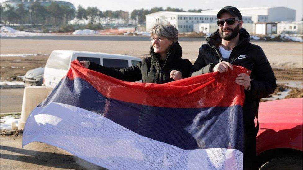 Fans of Serbian tennis player Novak Djokovic wait for him to arrive at Nikola Tesla airport, after the Australian Federal Court upheld a government decision to cancel his visa to play in the Australian Open, in Belgrade, Serbia