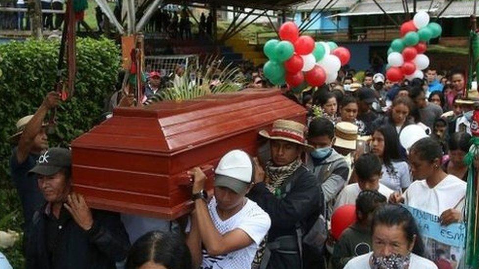 People carry the coffin of 14-year-old environmental activist Breiner David Cucuñame, who was killed in January