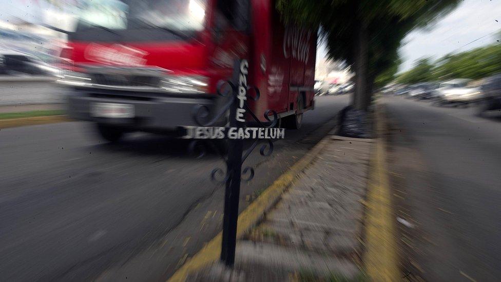 A cross placed on a street indicates the point where a man was murdered in Culiacan, Sinaloa state, Mexico