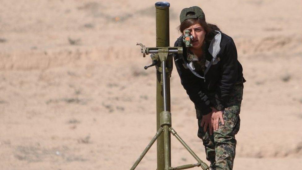 A Syrian Democratic Forces (SDF) female fighter adjusts a mortar in northern Deir al-Zor province ahead of an offensive against Islamic State militants, Syria on 21 February 2017.