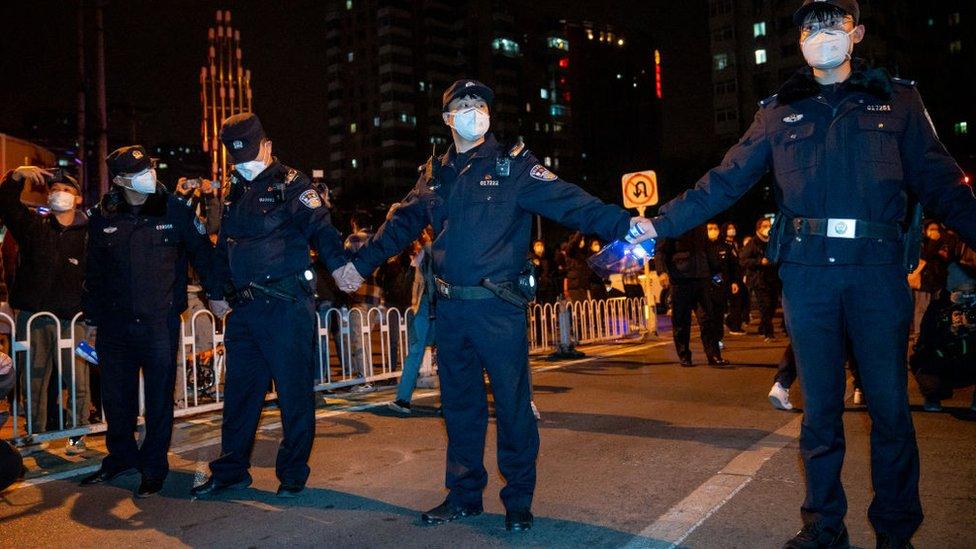 Police officers stand guard in Beijing.