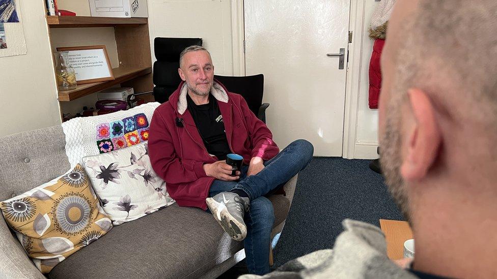 Man having a cup of tea in the charity room