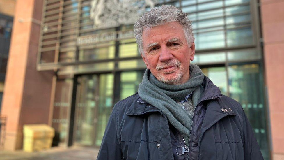 A man outside court in Bristol campaigning against airport expansion