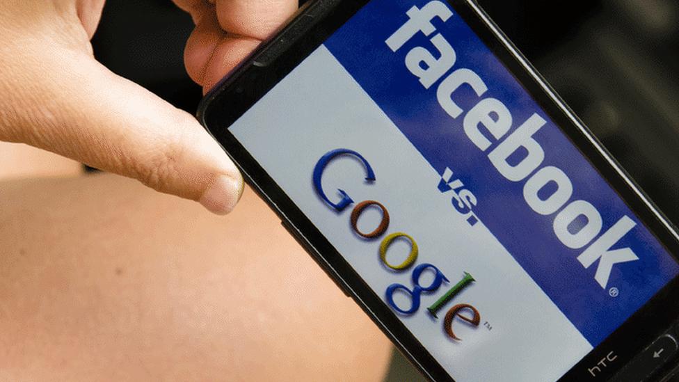 Logos of Facebook and Google on phone