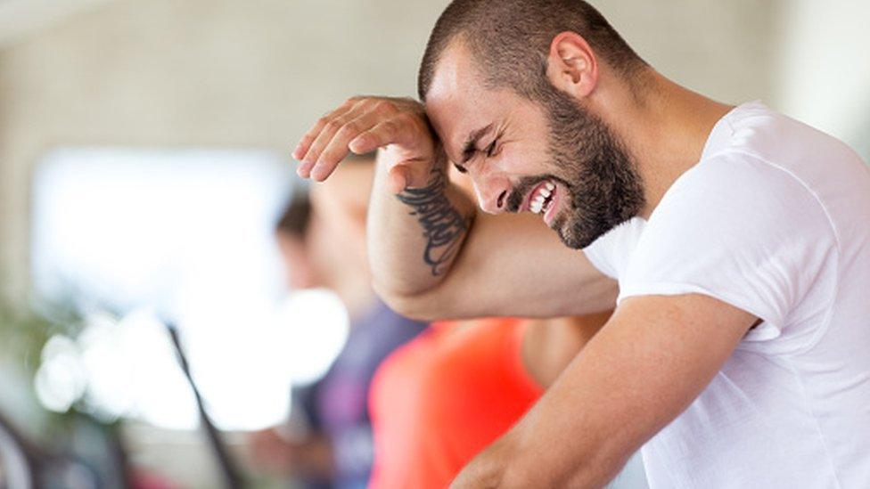 Man exercising vigorously in a gym