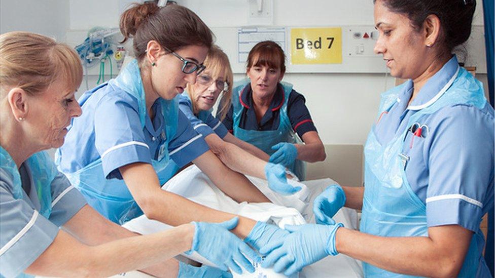 Nurses turning a patient