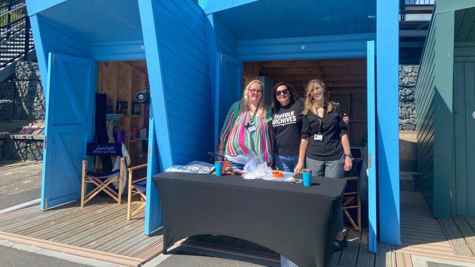 Three staff members who are running the pop-up library in a beach hut at Lowestoft, Suffolk