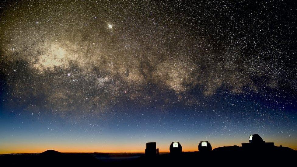 view of the Milky Way over telescopes