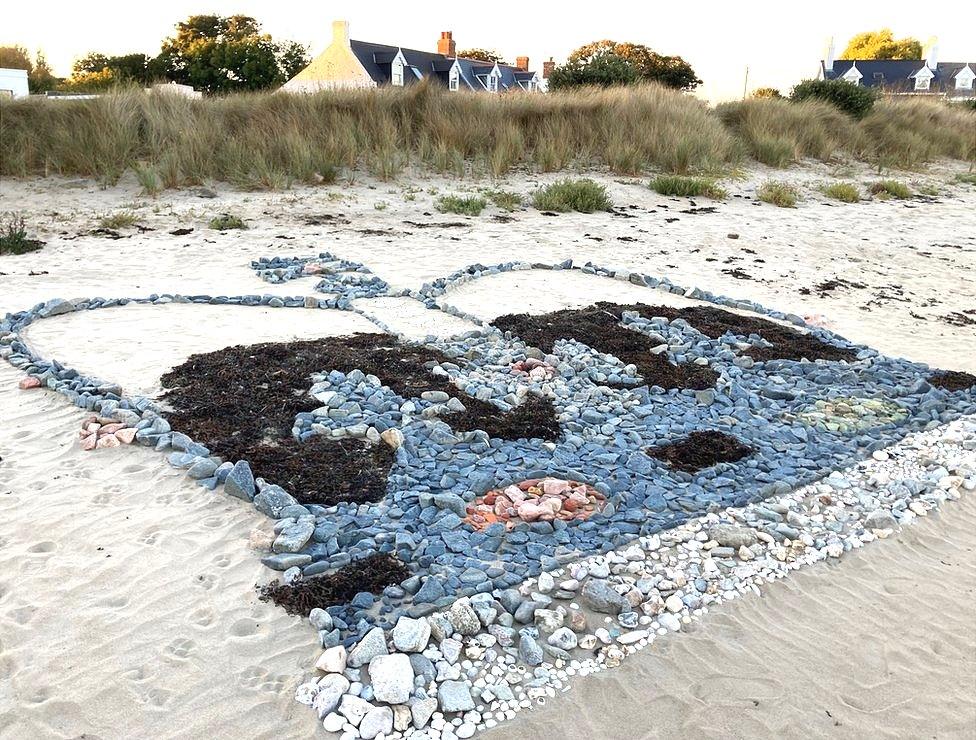 Giant crown picture made of beach stones