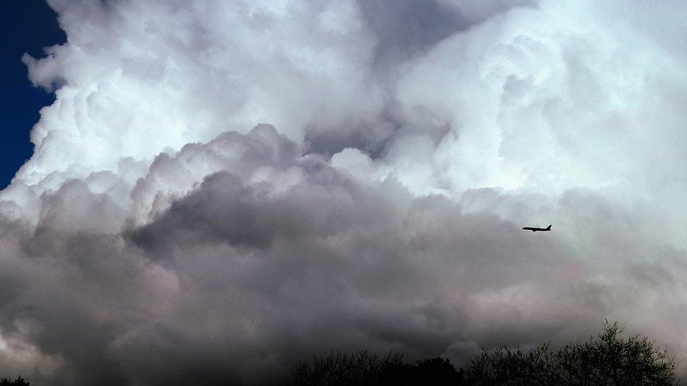 Plane flying through clouds