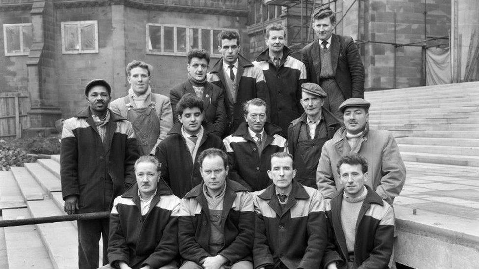 Group of builders outside cathedral