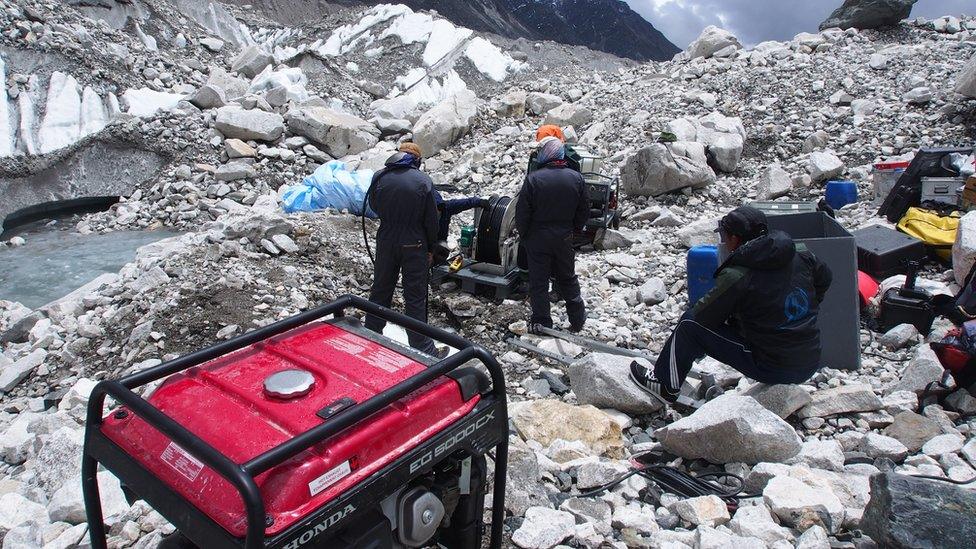 The team drill into the glacier