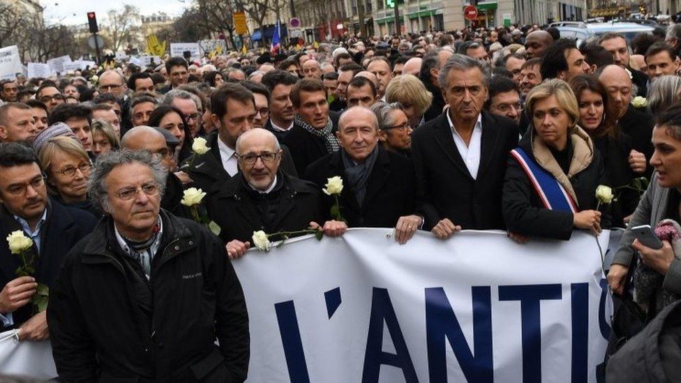 People take part in a silent march in Paris, France. Photo: 28 March 2018