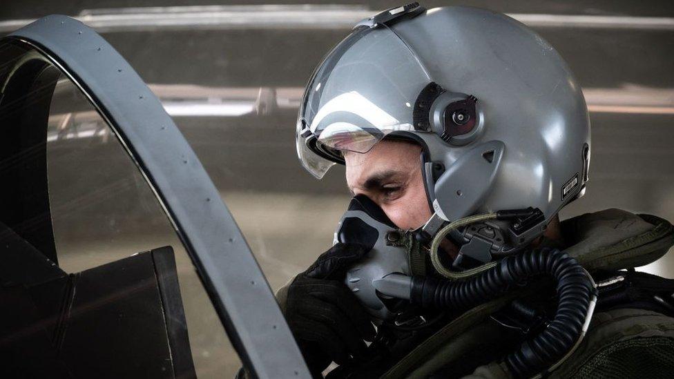 A French rafale fighter jet pilot gets ready in his aircraft prior to taking off for a daily NATO border watch mission sortie over Poland at the Mont-de-Marsan airbase, southwestern France