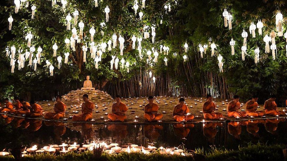 Novice Buddhist monks sit to pray at Wat Phan Tao temple to mark the beginning of the annual Yi Peng festival in the popular tourist city of Chiang Mai in the north of Thailand