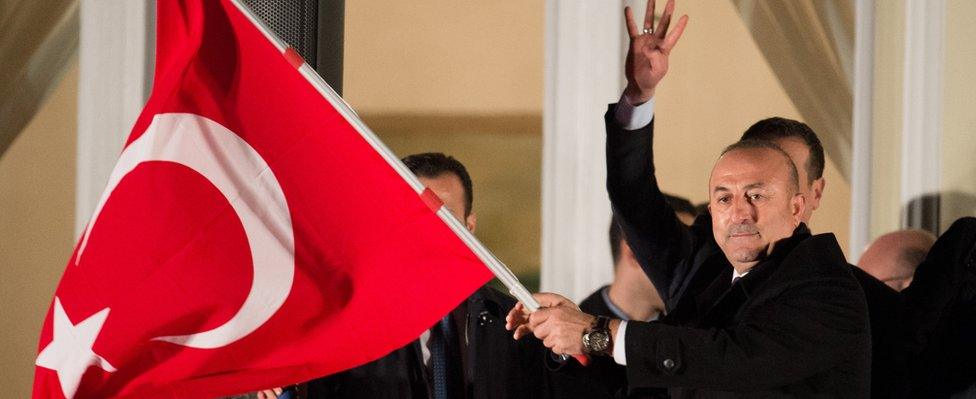 Mevlut Cavusoglu addresses supporters from the balcony of the consul's residence in Hamburg on 7 March