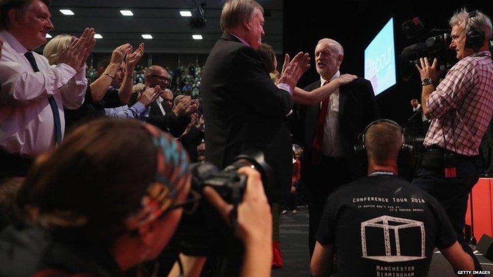 Jeremy Corbyn being greeted on stage after finishing his leader's speech