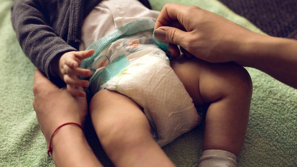 Generic baby having nappy changed