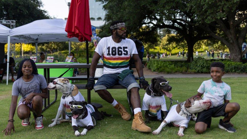 A family and their dogs with '1965' on the mans shirt