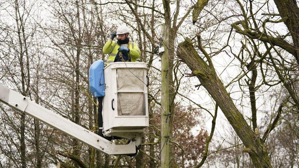 Engineer repairing power and telephone lines following Storm Arwen