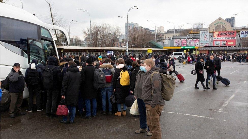 People trying to leave Kyiv by bus