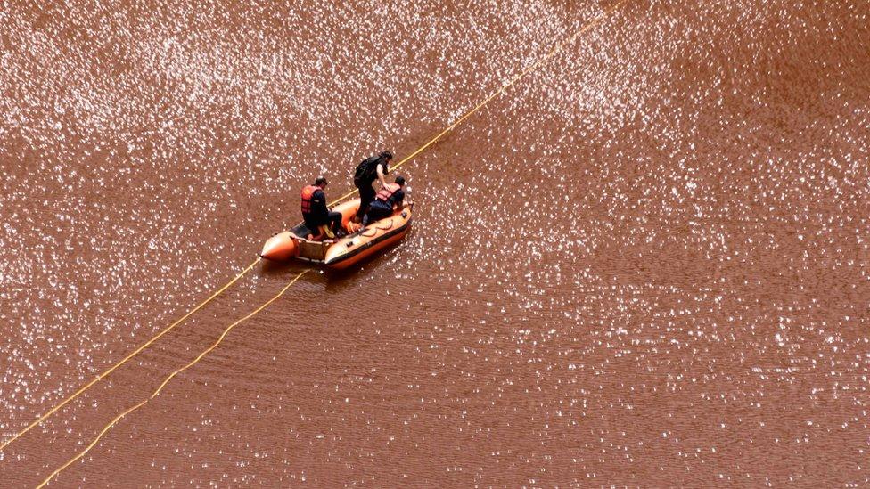 A boat with investigators in the red lake