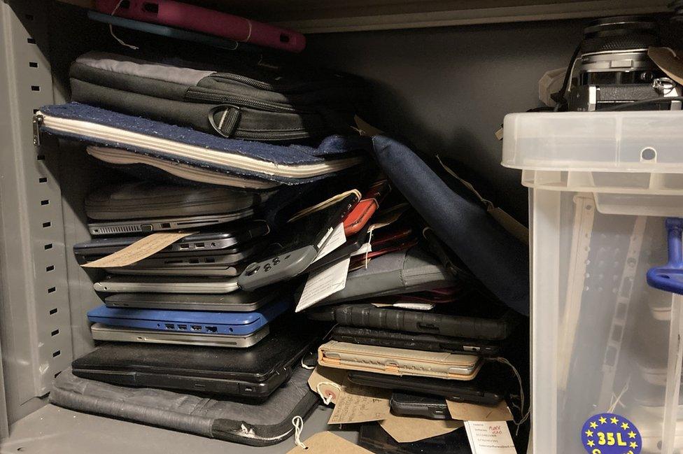 Laptops and other technology in a cabinet