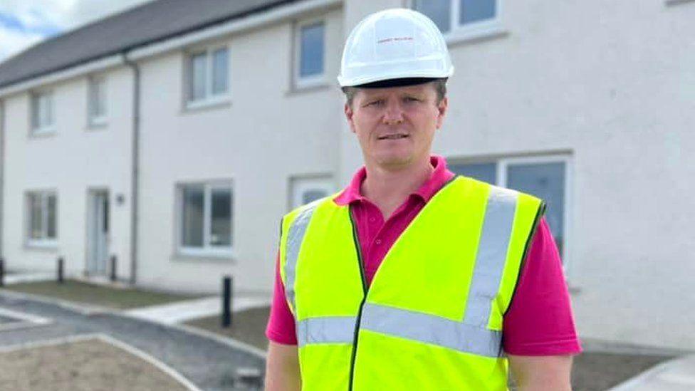 Stephen Kemp in front of houses