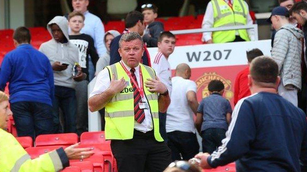 Supporters leaving Old Trafford