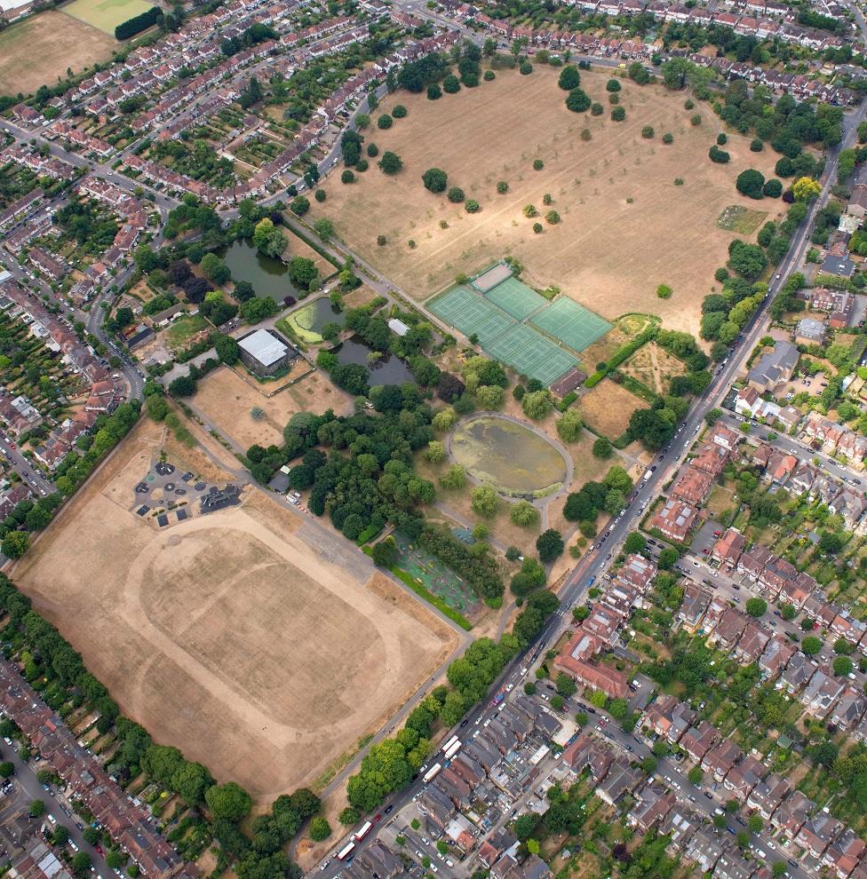 The grass on playing fields near Arnos Grove, North East London, is seen scorched and yellow