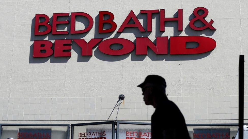 Customer walking in front of a Bed, Bath & Beyond store