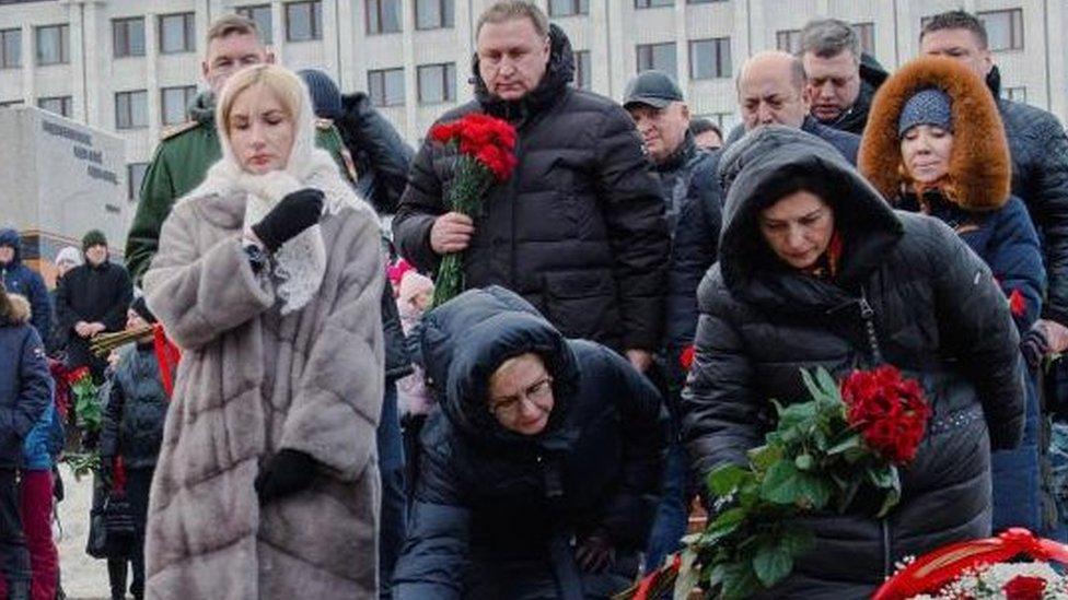 Participants lay flowers near the Eternal Flame memorial in Samara, Russia, January 3, 2023