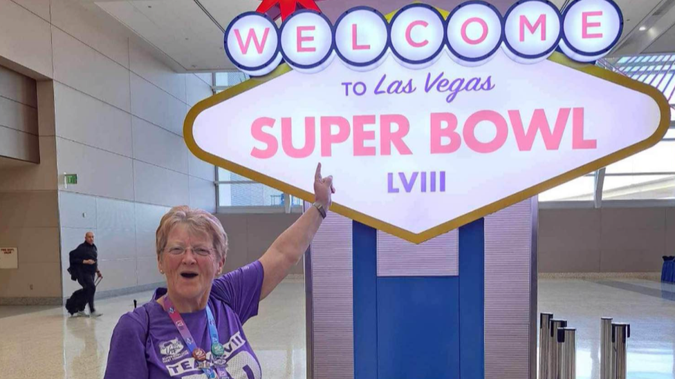 Pat Garner stood next to a super bowl sign