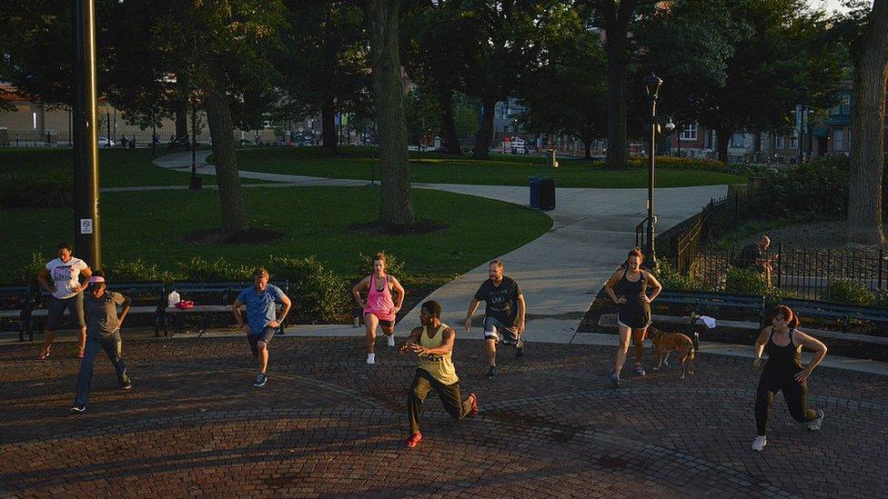 People exercise in Washington Park in the Over-The-Rhine neighborhood