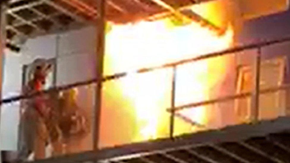 Handout videograb of fire fighters tackling the fire after it had just started on the top floors of a student accommodation building in Bolton