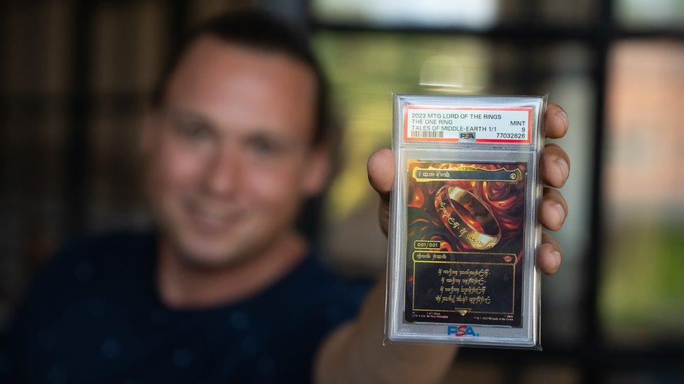 Brook Trafton holds up the ultra-rare 'One Ring' card