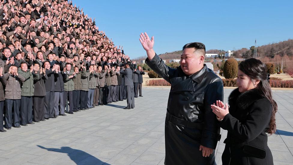 North Korean leader Kim Jong Un and his daughter attend a photo session with the scientists, engineers, military officials and others involved in the test-fire of the country's new Hwasong-17 intercontinental ballistic missile