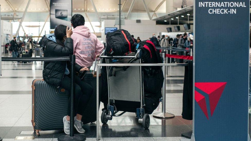 Travellers move through the departures hall at Terminal 4 of John F Kennedy International Airport in New York City, 24 December 2021