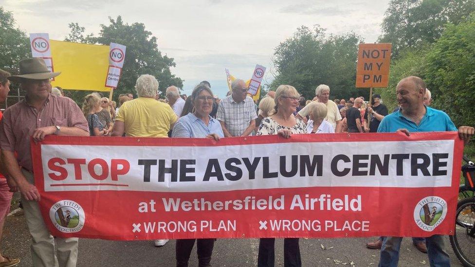 Protesters in Wethersfield, Essex holding large banners