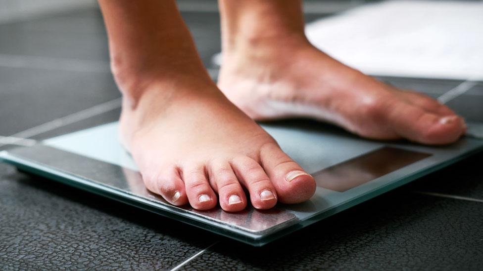 A person standing on scales