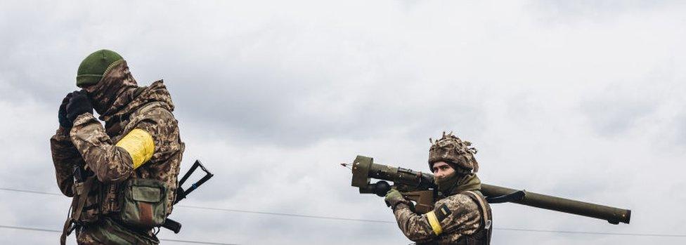 A Ukrainian army soldier takes aim with an anti-aircraft missile, March 4, 2022, in Irpin, Ukraine.